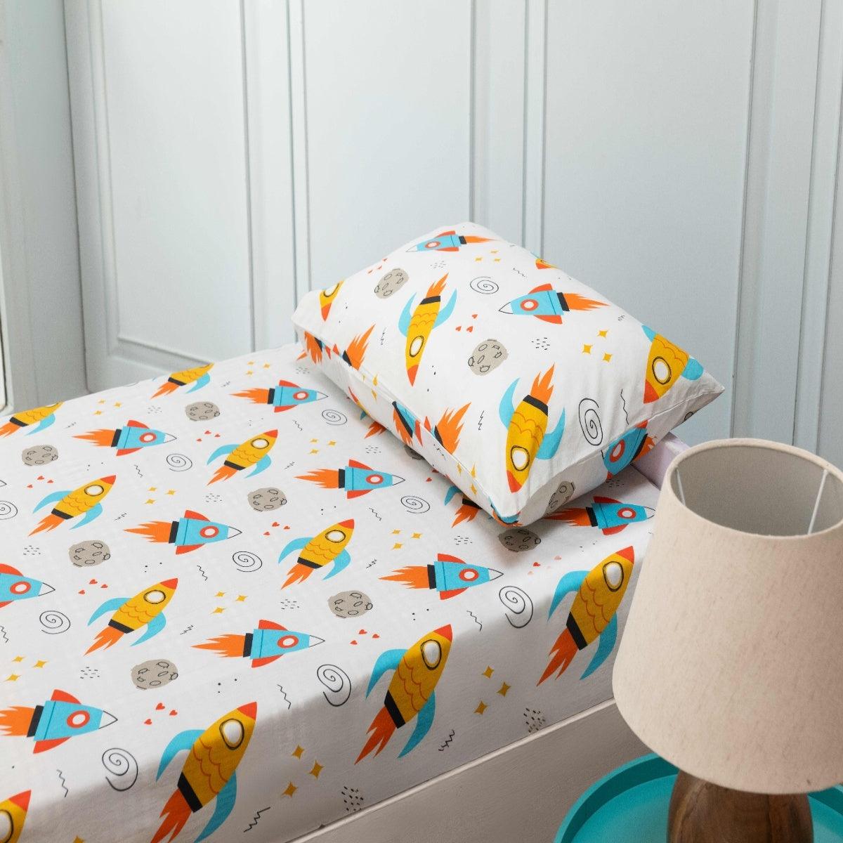 A kids bedroom showcasing a fully coordinated outer space theme bedsheet, including pillowcase.
