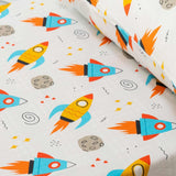 Close up image of Playful Plunge's space theme bedsheet for kid showing the print of rocket, planets, cosmic.