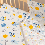 Close-up of Outer Space baby blanket showing stars, rockets, and galaxies in peaceful colors.