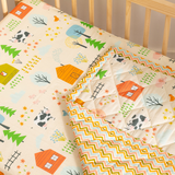 Close-up of baby blanket showing colorful farm animal design cow, village house, trees flower in premium cotton fabric.
