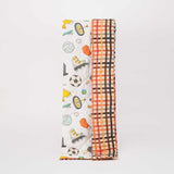 Playful Plunge kids comforter with sport-themed print featuring balls and equipment, shown laid out on a bed with soft stitching detail